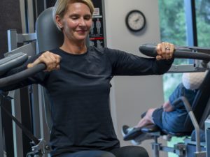 Woman builds strength safely on specialty equipment.